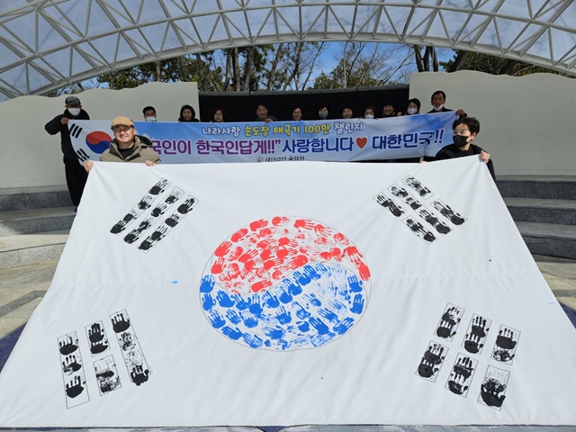 전남국학원이 개최한 3.1절 경축행사에서 참가자들이 손도장으로 만든 태극기를 펼쳐보이고 있다. 이미지 전남국학원
