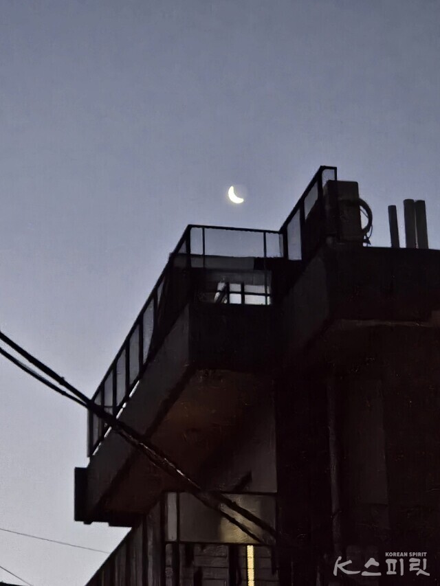 주택가 건물 위에 선명한 초생달. 사진 강나리 기자.