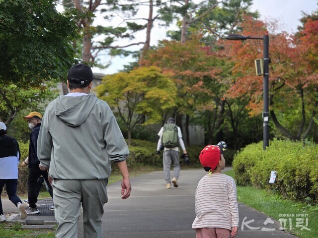 이제 막 단풍이 들기 시작한 남산둘레길을 걷는 아버지와 아들. 사진 강나리 기자.